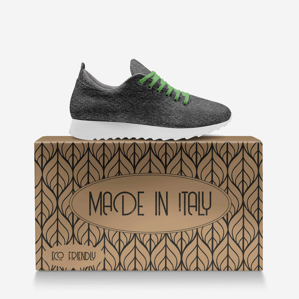 Eco-friendly, vegan 'Align' sneakers with a gray textured upper and green laces, paired with a eco-friendly box, showcasing sustainable luxury.