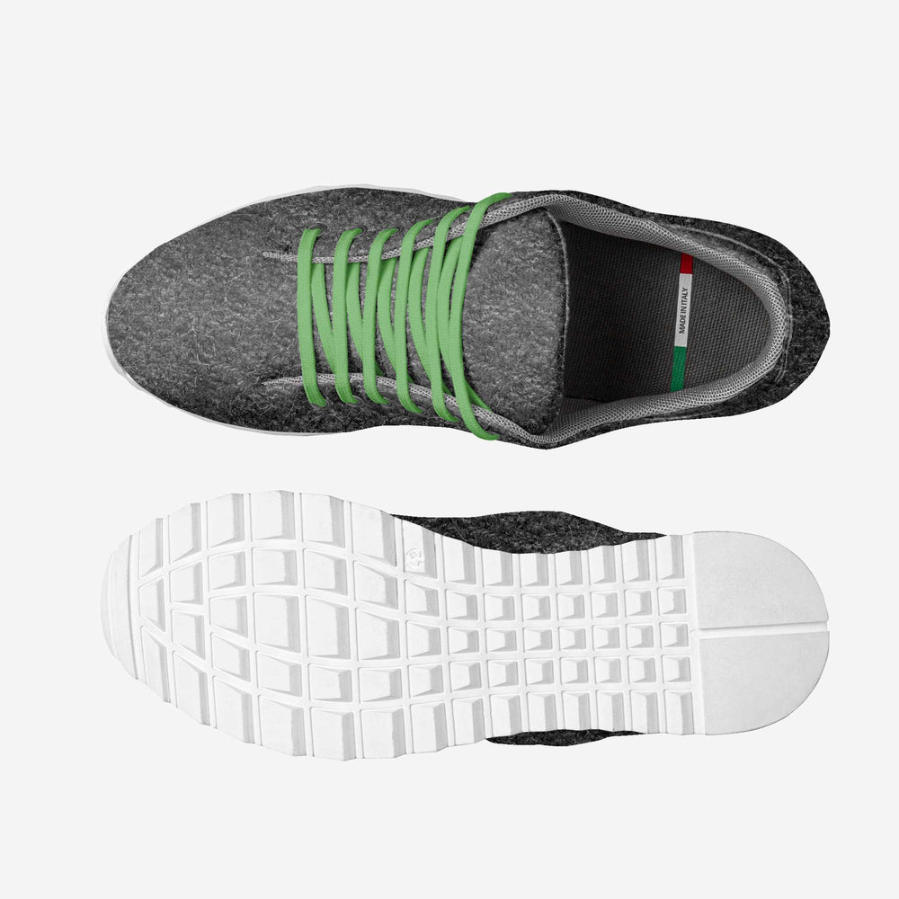 Eco-friendly, vegan 'Align' sneakers with a gray textured upper and green laces, paired with sweatpants, showcasing sustainable luxury.