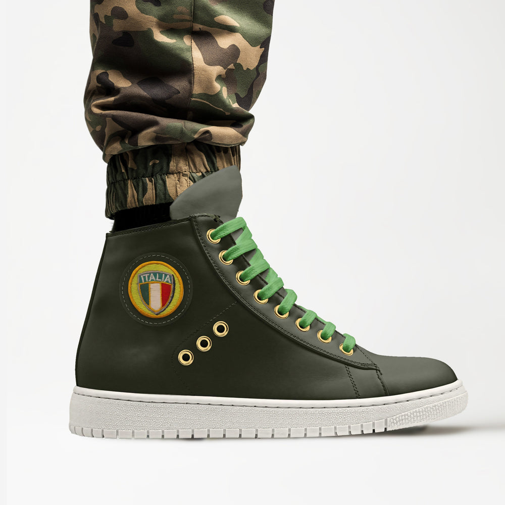 Eco-friendly 'Eco' high-top sneakers in olive green with a retro Italian shield patch, crafted from vegan materials for a bold, sustainable look, featured with camo pants.