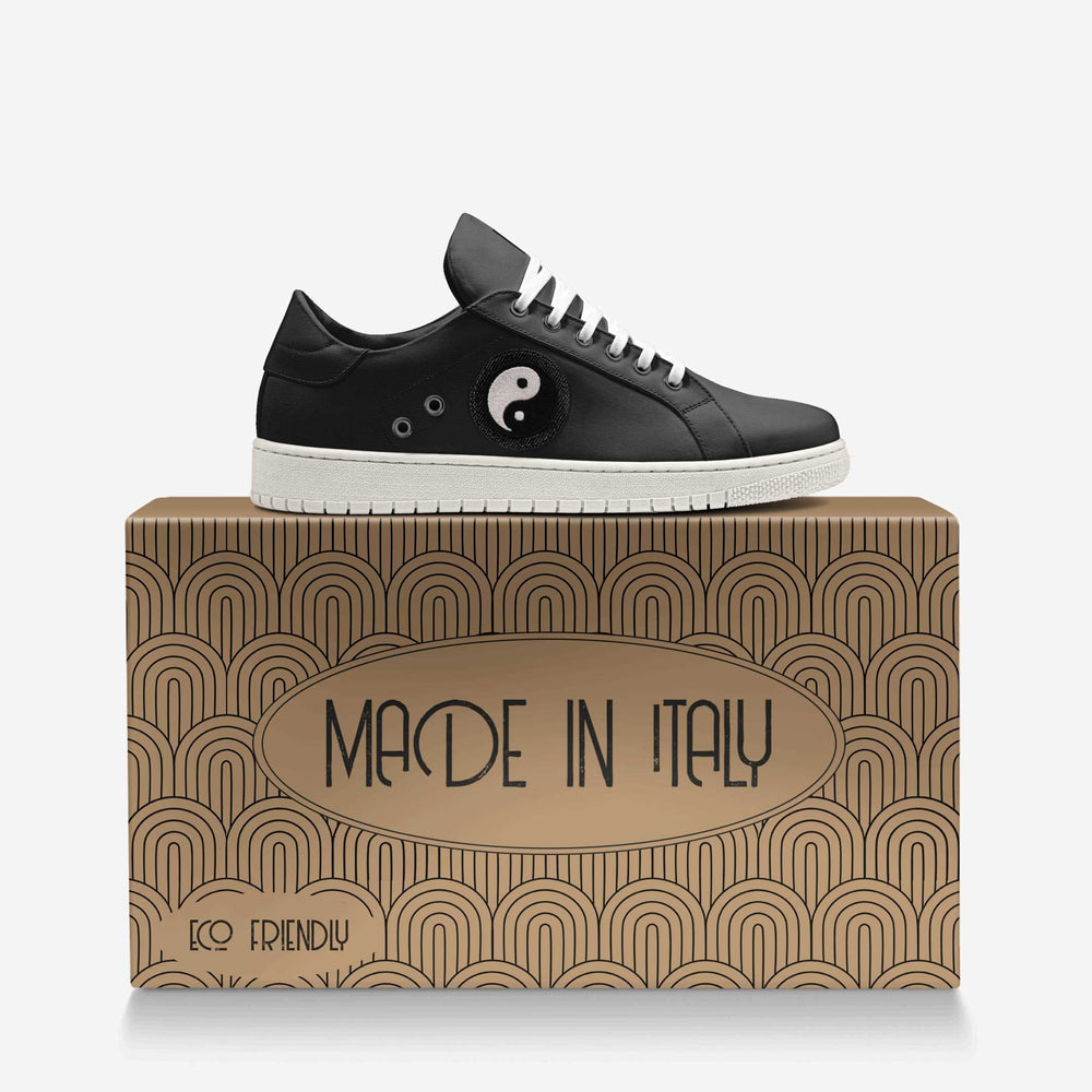 Vegan 'Gravity' sneakers in sleek low-top black, featuring a Yin-Yang patch on the side, blending eco-conscious materials with symbolic design.