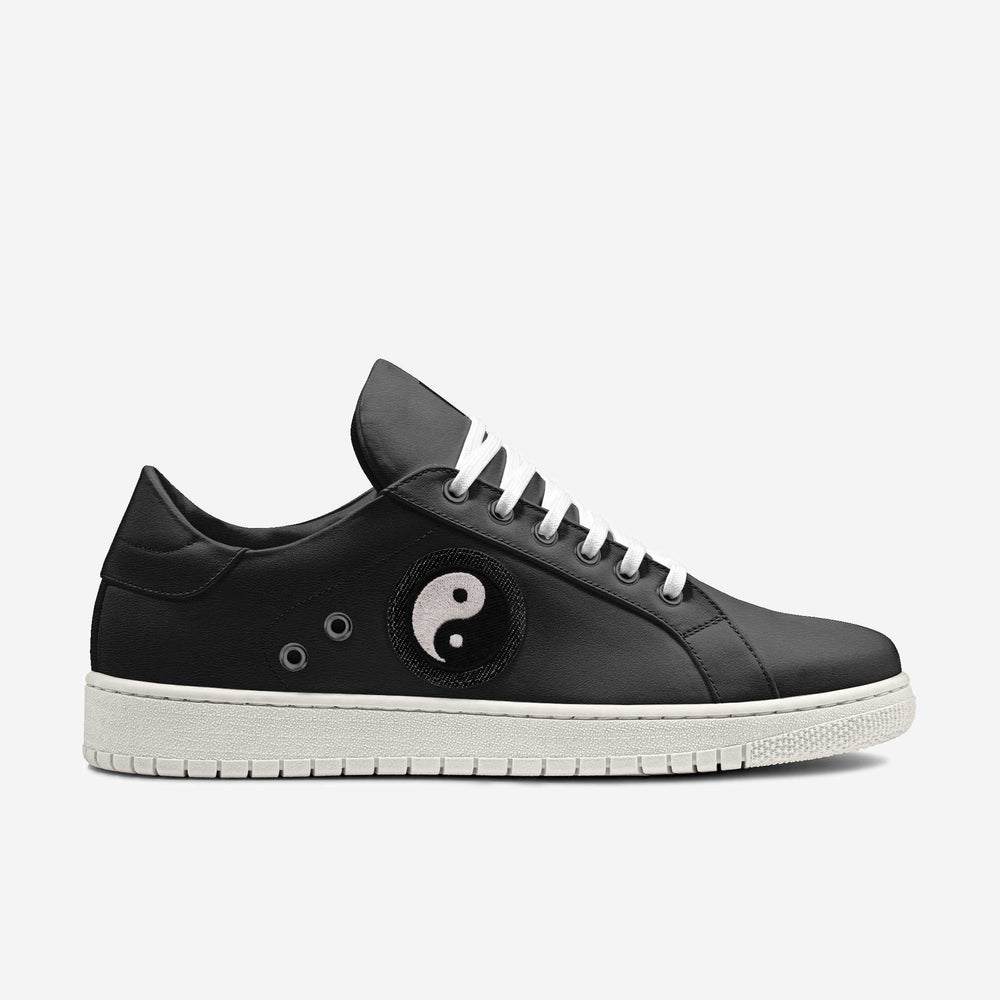 Vegan 'Gravity' sneakers in sleek low-top black, featuring a Yin-Yang patch on the side, blending eco-conscious materials with symbolic design.