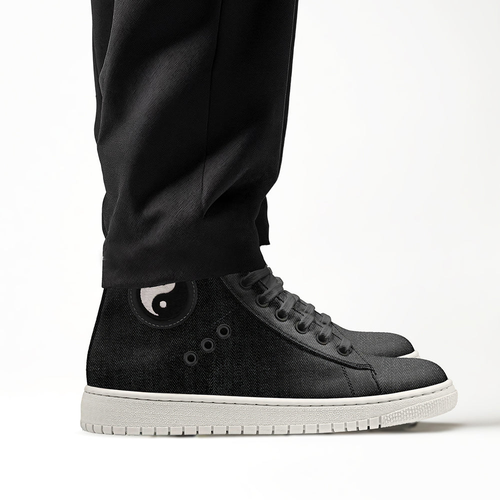 Vegan 'Nova' high-top sneakers in black denim fabric, featuring a circular yin and yang patch and black laces, designed for sustainable style and comfort.