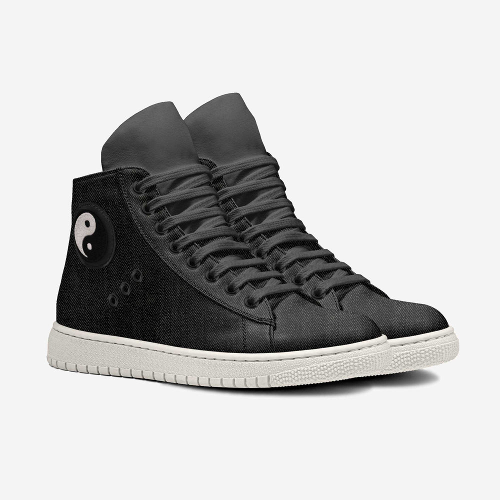 Vegan 'Nova' high-top sneakers in black denim fabric, featuring a circular yin and yang patch and black laces, designed for sustainable style and comfort.
