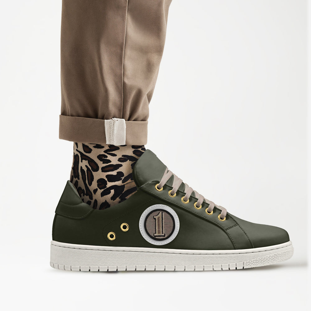 Sustainable 'Orbit' sneakers in olive green, paired with leopard print socks, delivering eco-conscious style with a standout number 1 patch.