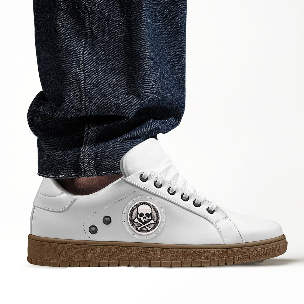 Eco-friendly 'Stride' sneakers with a classic white upper and striking skull patch, crafted from cruelty-free materials for an edgy, conscious look.