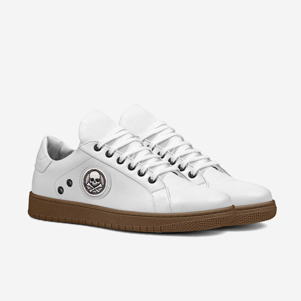 Eco-friendly 'Stride' sneakers with a classic white upper and striking skull patch, crafted from cruelty-free materials for an edgy, conscious look.